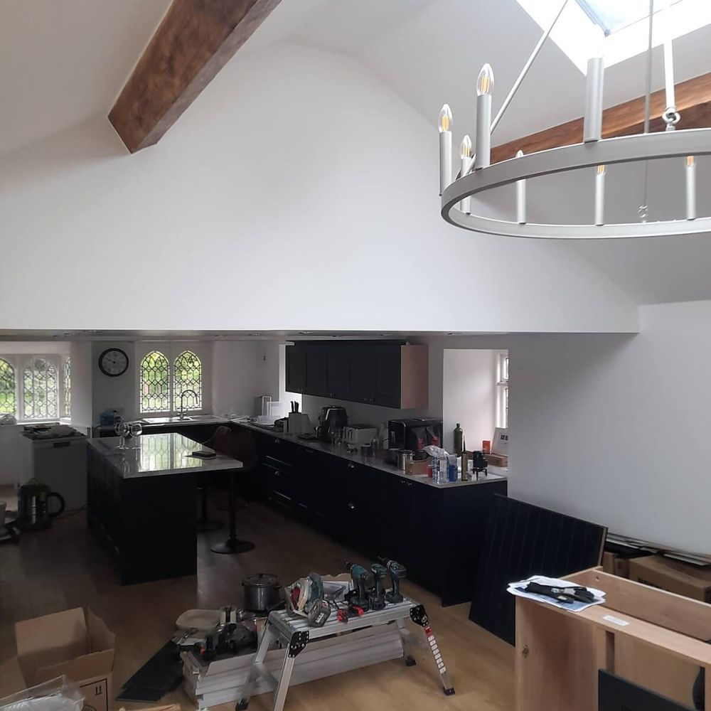 Renovated interior with vaulted ceiling and exposed timber beams