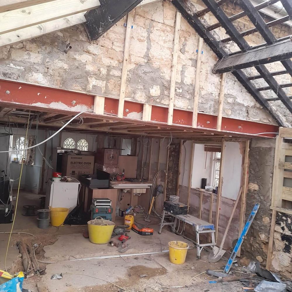 Major interior refurbishment showing exposed stone walls and new structural steelwork